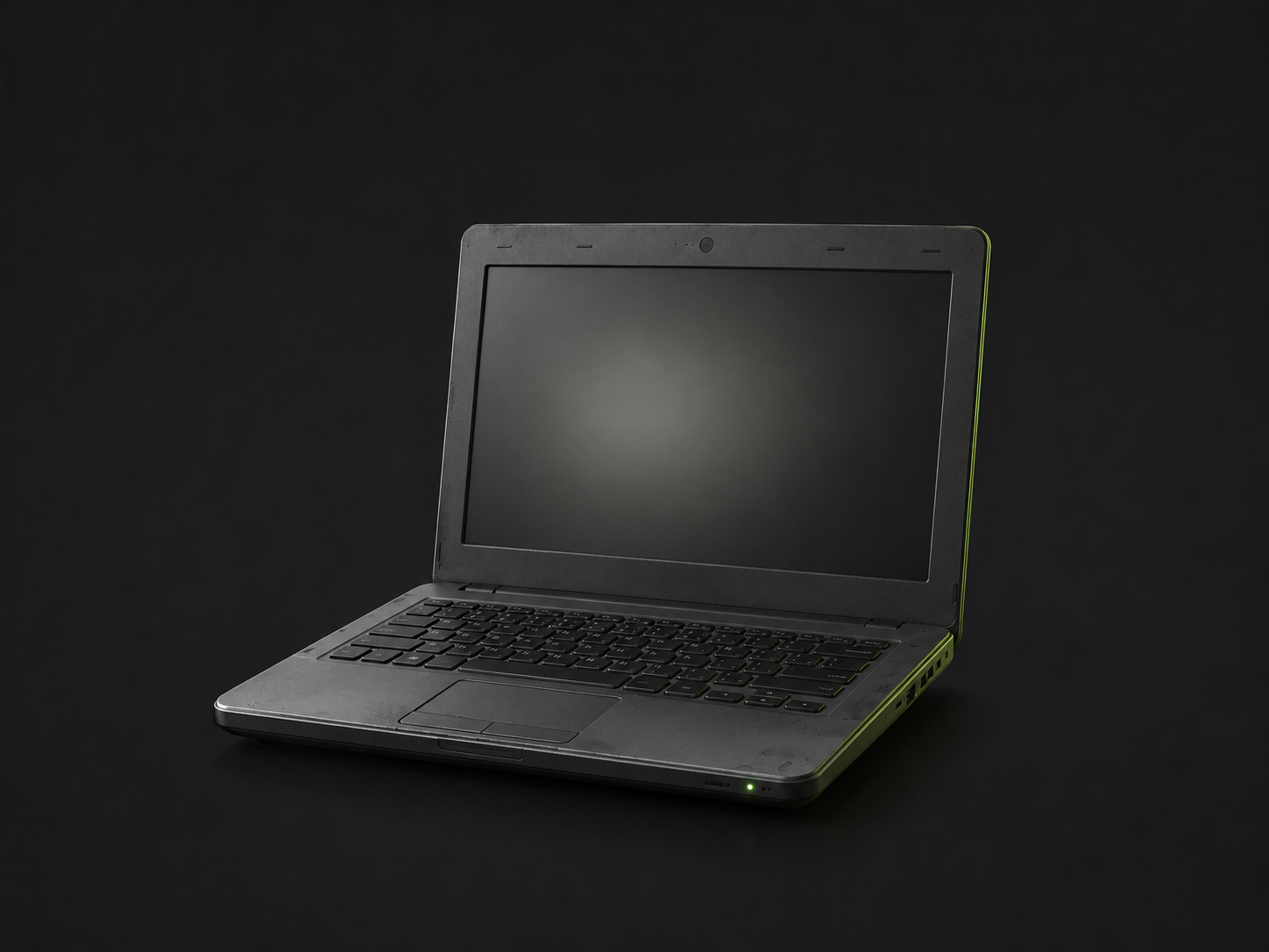 A used 2016 budget laptop, screen off, on a plain dark background.
